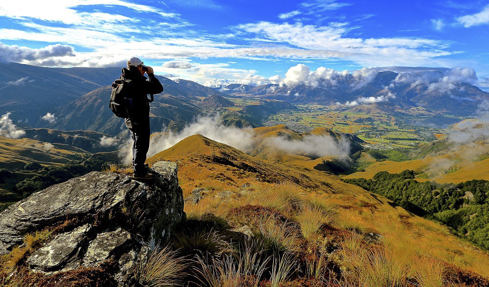 Someone on top of a mountain with a beautiful view.